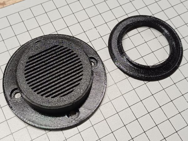 Vardo Systems Black Grill Vent and 32mm hose collar on a table showing scale